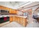 Traditional kitchen featuring wood cabinets, island, and appliances at 9423 El Campo Ave, Englewood, FL 34224