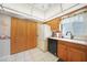 Traditional kitchen featuring wood cabinets, white countertops, and appliances at 9423 El Campo Ave, Englewood, FL 34224