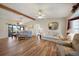 Spacious living room with hardwood floors, ceiling fans, and a sliding glass door to the patio at 9423 El Campo Ave, Englewood, FL 34224