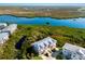 Aerial view of home overlooking a large waterway surrounded by trees and greenery at 10310 Coral Landings Ct # 98, Placida, FL 33946