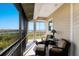 Screened balcony with outdoor seating and scenic water views at 10310 Coral Landings Ct # 98, Placida, FL 33946