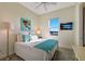 Bright bedroom with a large window and comfortable, modern decor and furniture at 10310 Coral Landings Ct # 98, Placida, FL 33946