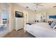 Spacious bedroom with a chest of drawers, tv, and balcony access at 10310 Coral Landings Ct # 98, Placida, FL 33946