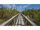 Picturesque boardwalk through lush greenery, perfect for a scenic stroll at 10310 Coral Landings Ct # 98, Placida, FL 33946