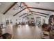 Spacious event space with high ceilings, exposed beams, ceiling fans and a stone fireplace at 10310 Coral Landings Ct # 98, Placida, FL 33946