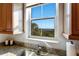 Bright window view from the kitchen, showcasing lush greenery and serene waterfront scenery at 10310 Coral Landings Ct # 98, Placida, FL 33946