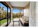 Inviting screened lanai with comfortable seating and views of the lush, green landscape at 10310 Coral Landings Ct # 98, Placida, FL 33946