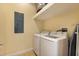 Convenient laundry room with washer, dryer, overhead shelf and adjacent ironing board at 10310 Coral Landings Ct # 98, Placida, FL 33946