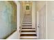Bright stairwell featuring wood stairs and white risers leading to the upper levels at 10310 Coral Landings Ct # 98, Placida, FL 33946