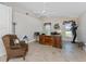 Office space featuring a wooden desk, comfortable chair, and natural light from the windows at 10308 Euston Ave, Englewood, FL 34224