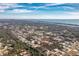 Expansive aerial view showcases a residential neighborhood near a waterway and the ocean, with lush greenery and blue skies at 1080 Panda Rd, Venice, FL 34293