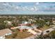 Aerial view highlighting the home with a large driveway and well-manicured front yard at 1080 Panda Rd, Venice, FL 34293
