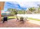 Backyard features a patio with outdoor seating, a grill, a white fence, and mature trees at 1080 Panda Rd, Venice, FL 34293