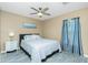 Comfortable bedroom with a full bed, a ceiling fan, and natural light from the window at 1080 Panda Rd, Venice, FL 34293