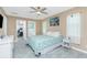 Cozy bedroom featuring a queen bed, ensuite entrances, a ceiling fan and calming decor at 1080 Panda Rd, Venice, FL 34293