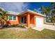 Inviting home with vibrant exterior, manicured front yard, covered porch, and an attached garage at 1080 Panda Rd, Venice, FL 34293