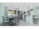 Open kitchen area features white cabinets, stainless appliances, granite countertops, breakfast bar, and dining area at 1080 Panda Rd, Venice, FL 34293