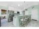 Modern kitchen with stainless steel appliances, granite countertops, bar seating, and a view of the outdoor patio at 1080 Panda Rd, Venice, FL 34293