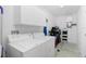 Functional laundry room with a washer, dryer, and ample storage cabinets at 1080 Panda Rd, Venice, FL 34293