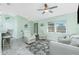 Bright living space with a ceiling fan, comfortable seating, and a clear view of the dining area and entryway at 1080 Panda Rd, Venice, FL 34293