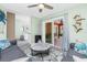 Comfortable living room with coastal decor, ceiling fan, sliding glass door, and open to the kitchen at 1080 Panda Rd, Venice, FL 34293