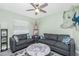 Comfortable living room features coastal decor, ceiling fan, and natural light from the window at 1080 Panda Rd, Venice, FL 34293