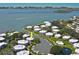 Aerial view of waterfront community featuring boat docks, pool, lush landscaping, and easy access to open water at 11000 Placida Rd # 702, Placida, FL 33946