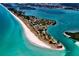 Stunning aerial view of a pristine beach with turquoise water and a vibrant coastal community at 11000 Placida Rd # 702, Placida, FL 33946