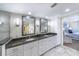 Bathroom featuring a double vanity, elegant mirrors, and a separate glass-enclosed shower at 11000 Placida Rd # 702, Placida, FL 33946