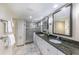 Bathroom featuring dual sinks with granite countertops, and a glass shower at 11000 Placida Rd # 702, Placida, FL 33946