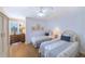 Bright guest bedroom with two twin beds, hardwood floors, a ceiling fan, and ample natural light at 11000 Placida Rd # 702, Placida, FL 33946