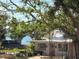 Charming exterior view of a home with lush greenery and a glimpse of the waterfront at 11000 Placida Rd # 702, Placida, FL 33946