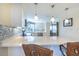 Spacious open kitchen featuring a large quartz countertop, bar seating, stainless steel appliances, and mosaic backsplash at 11000 Placida Rd # 702, Placida, FL 33946
