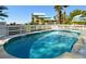 Inviting pool with bright blue water in a fenced-in area near condos and lush greenery at 11000 Placida Rd # 702, Placida, FL 33946