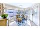 Cozy sunroom features large windows, comfortable seating, and scenic views of the surrounding neighborhood at 11000 Placida Rd # 702, Placida, FL 33946