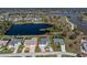 Aerial view of the property with lush landscaping and a tranquil lake at 12 Sportsman Ter, Rotonda West, FL 33947