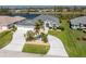 Aerial view of a single-story home with a three-car garage and landscaped yard at 12 Sportsman Ter, Rotonda West, FL 33947