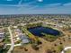 Gorgeous aerial view of the property with in-ground pool and lake bordering the back of the lot at 12 Sportsman Ter, Rotonda West, FL 33947