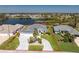 Aerial view of the property with a meticulously landscaped yard and circular driveway at 12 Sportsman Ter, Rotonda West, FL 33947