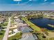 Aerial view of the property with a screened pool and water view at 12 Sportsman Ter, Rotonda West, FL 33947