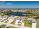 An aerial view of a home with mature landscaping overlooking a pond at 12 Sportsman Ter, Rotonda West, FL 33947