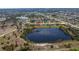 A scenic aerial view of the property bordering a tranquil lake in a well-planned community at 12 Sportsman Ter, Rotonda West, FL 33947