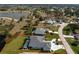 Aerial view of the property with lush landscaping, screened pool and lake at 12 Sportsman Ter, Rotonda West, FL 33947