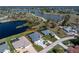 Aerial view of property showcasing meticulously landscaped yard and lake at 12 Sportsman Ter, Rotonda West, FL 33947
