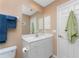 Bathroom features a toilet, vanity with white cabinets, a mirror, and a door to a closet at 12 Sportsman Ter, Rotonda West, FL 33947