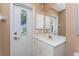 Bathroom features a white vanity, a large mirror, and a door with built in blinds at 12 Sportsman Ter, Rotonda West, FL 33947
