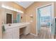 Bright bathroom featuring a vanity with a makeup area, a mirror, and tile flooring at 12 Sportsman Ter, Rotonda West, FL 33947