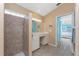 Bathroom featuring tiled floor, walk-in shower and dual sink vanity, as well as access to the bedroom at 12 Sportsman Ter, Rotonda West, FL 33947