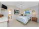 Bedroom showcasing a queen-size bed, a ceiling fan, tile floors, and ensuite bathroom at 12 Sportsman Ter, Rotonda West, FL 33947