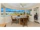 Dining area offering lake views through large windows and comfortable seating at 12 Sportsman Ter, Rotonda West, FL 33947